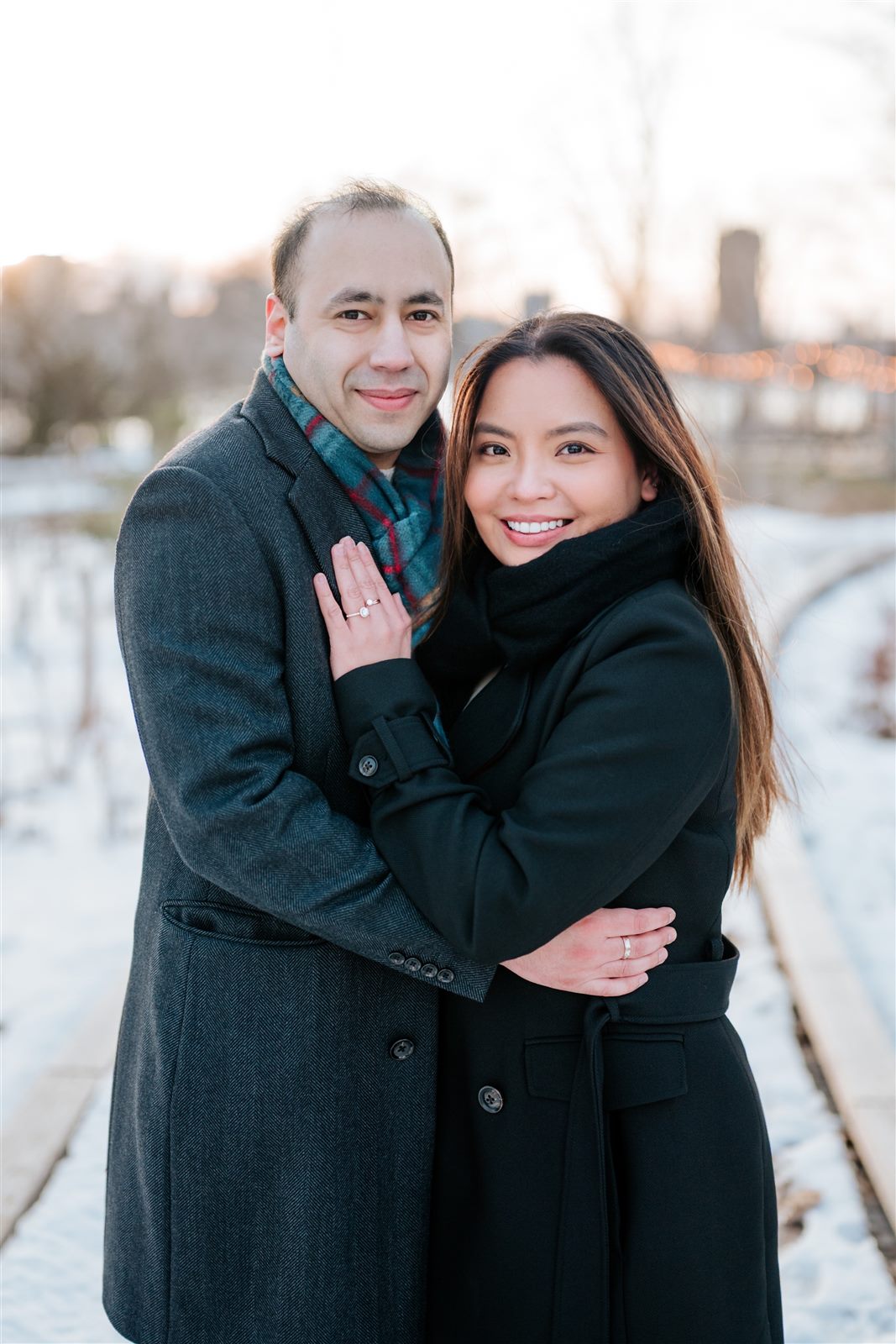 Manny and Arbie embracing outdoors in winter
